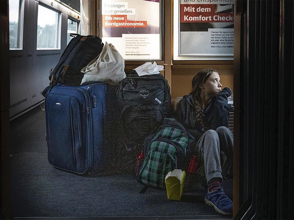 Climate activist Greta Thunberg sitting on the floor of a Deutsche Bahn train surrounded by suitcases: Twitter/@GretaThunberg/AP