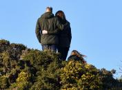 <p>The Duke and Duchess of Cambridge stand on Howth Cliffs with their arms wrapped around each other during their trip to Dublin, Ireland. </p>