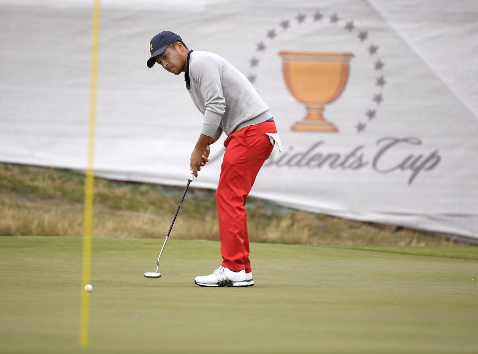 U.S. team player Xander Schauffele putts on the 14th green in their foursome match during the President's Cup golf tournament at Royal Melbourne Golf Club in Melbourne, Saturday, Dec. 14, 2019. (AP Photo/Andy Brownbill)