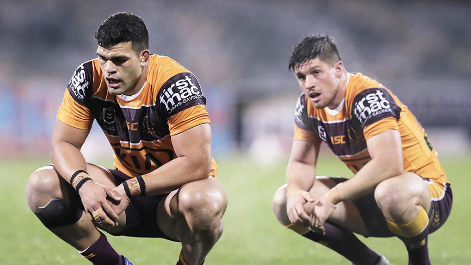 David Fifita (pictured left) and Cory Paix (pictured right) tire during a match for the Broncos.