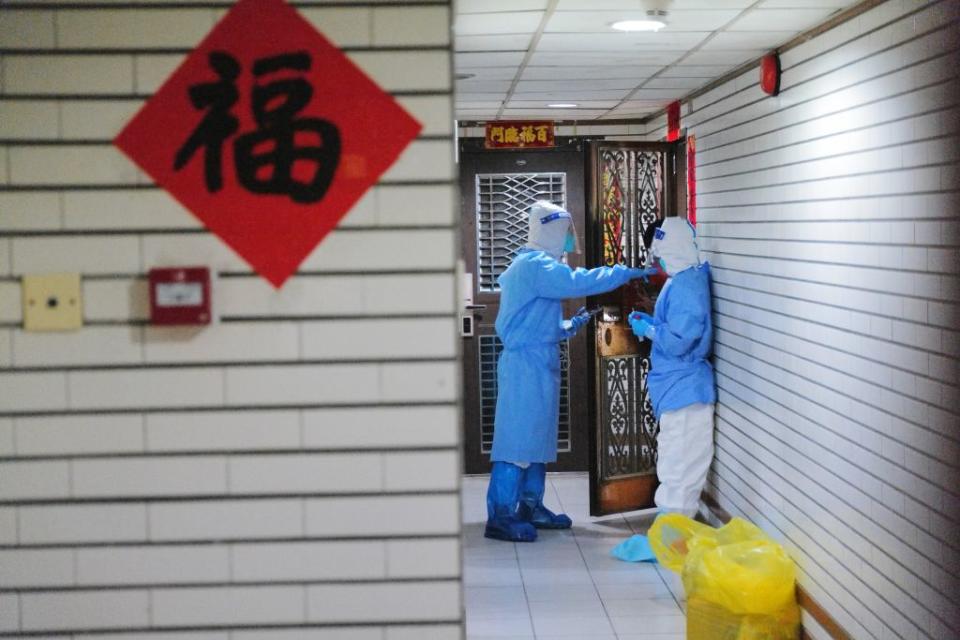 Medical workers carry out door-to-door nucleic acid test at a residential block under restrictions to halt the spread of the Covid-19 coronavirus on Mar. 14, 2022 in Shenzhen, Guangdong, China.<span class="copyright">Chen Wen/China News Service via Getty Images</span>