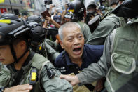 A protester is detained in Hong Kong on Sunday, Sept. 29, 2019. Protesters chanted slogans and heckled police as they were pushed back behind a police line. (AP Photo/Vincent Thian)