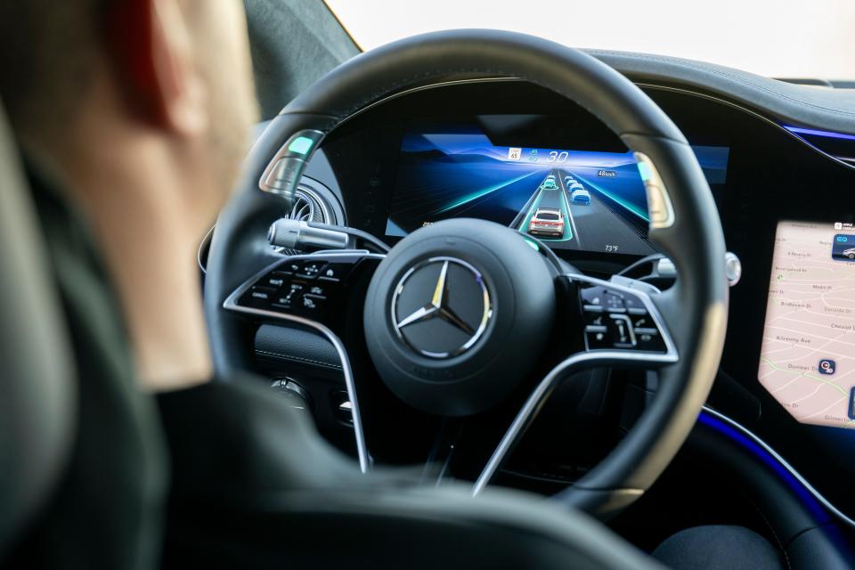 A close up of a Mercedes-Benz steering wheel running Drive Pilot software. 