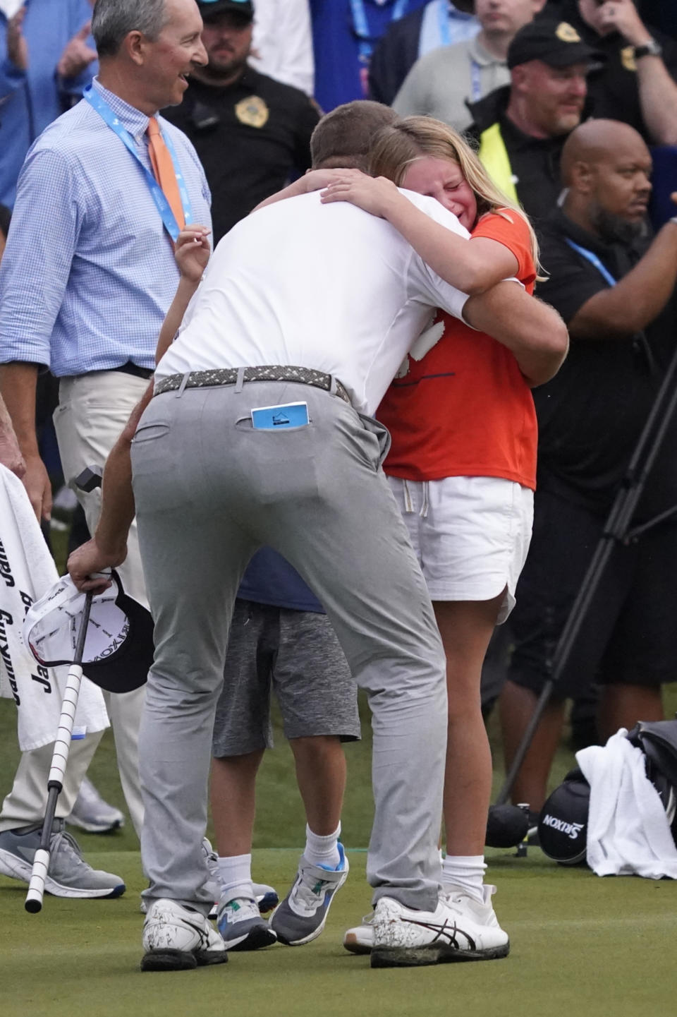 Lucas Glover hugs his daughter Lucille after winning the Wyndham Championship golf tournament in Greensboro, N.C., Sunday, Aug. 6, 2023. (AP Photo/Chuck Burton)