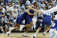 Duke forward Wendell Moore Jr., center, celebrates with guard Jordan Goldwire and forward Joey Baker (13) following Moore's game-winning shot in overtime of an NCAA college basketball game against North Carolina in Chapel Hill, N.C., Saturday, Feb. 8, 2020. (AP Photo/Gerry Broome)