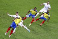 Ecuador's Jorge Guagua (2) heads the ball to his teammates as France's Antoine Griezmann (11) defends