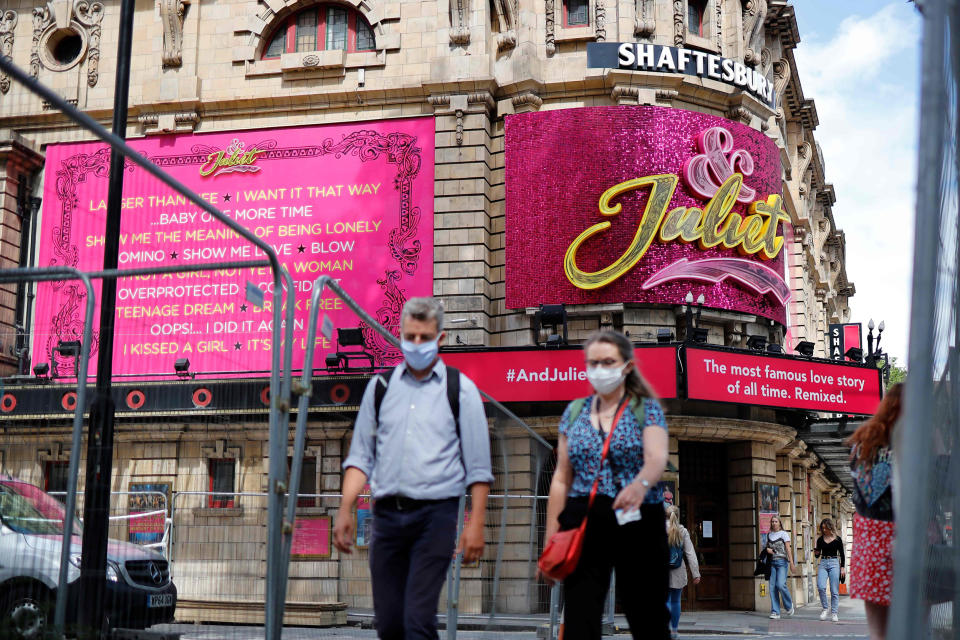 Image: Pedestrians walk past the Shaftesbury Theatre, which remains closed due to restrictions to slow the spread of the novel coronavirusm, in London's West End (Tolga Akmen / AFP - Getty Images)
