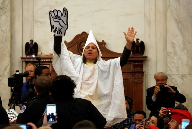 A protester dressed as a Klansman disrupts the start of a Senate Judiciary Committee confirmation hearing for U.S. Attorney General-nominee Senator Jeff Sessions on Capitol Hill. Kevin Lamarque / Reuters