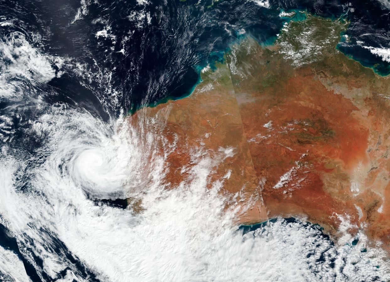 <p>Satellite image released by NASA shows Tropical cyclone Seroja hitting the coast of western Australia on 11 April</p> (AP)