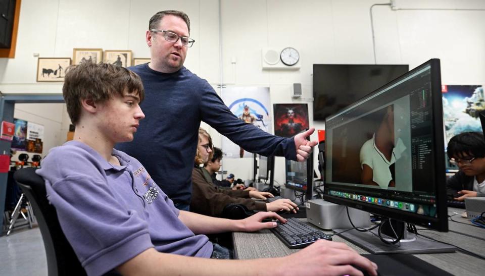 Animation teacher Heath Grant works with co-director Ian Wohlstadter on a student film in the advanced animation class at Downey High School in Modesto, Calif., Thursday, April 4, 2024. After winning a prestigious award in November, students are at work on new animated film hoping to show at film festivals.