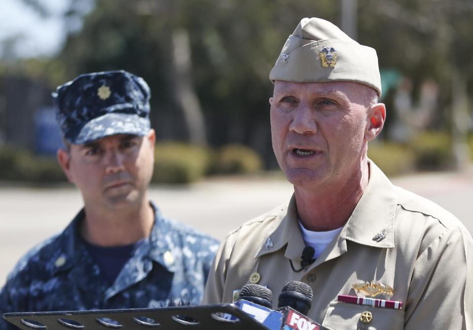 Captain Scott F. Adams, right, Commanding Officer Navy Base Point Loma, accompanied by Lt. Commander Steve Ruh, talks about an incident on the base in which a sailor was arrested for operating Airsoft weapon on the base Thursday, April 24, 2014, in San Diego. A second sailor who was a friend of the sailor with the weapon was also arrested. (AP Photo/Lenny Ignelzi)