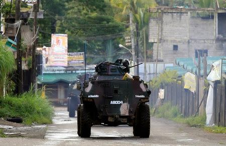 Armoured Personnel Carrier rides along the main street during the ongoing assault of government troops on insurgents from the Maute group, who have taken over large parts of Marawi City, Philippines June 1, 2017. REUTERS/Romeo Ranoco