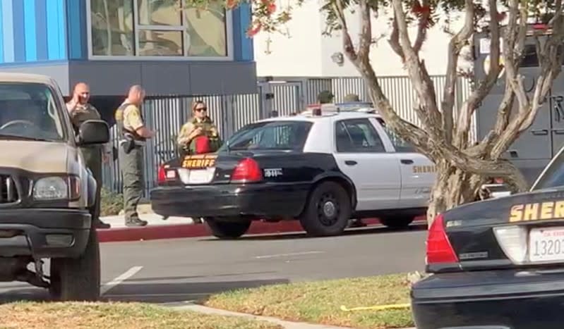 Sheriffs stand outside Saugus High School after a shooting, in Santa Clarita, California