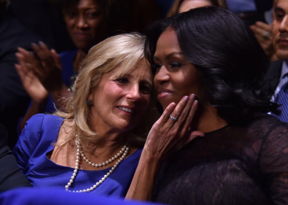 Michelle Obama (right) and Dr. Jill Biden, wife of Vice President Joe Biden, hug as President Obama speaks.