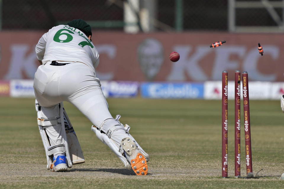 Pakistan's Agha Salman is bowled out by New Zealand's Ish Sodhi during the fifth day of first test cricket match between Pakistan and New Zealand, in Karachi, Pakistan, Friday, Dec. 30, 2022. (AP Photo/Fareed Khan)