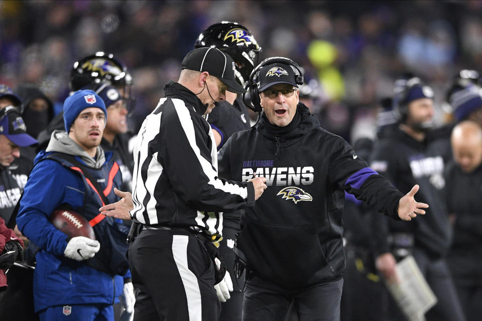 File-This Dec. 12, 2019, file photo shows Baltimore Ravens head coach John Harbaugh, right, talking to an official during the second half of an NFL football game against the New York Jets, in Baltimore. No matter how many spectacular plays Lamar Jackson and Russell Wilson made, officiating overshadowed the NFL this season. (AP Photo/Nick Wass, File)