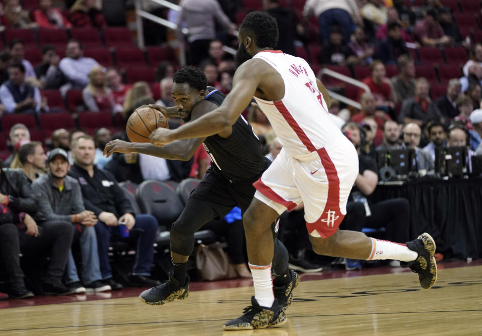 LA Clippers' Patrick Beverley, left, drives toward the basket as Houston Rockets' James Harden defends during the first half of an NBA basketball game Wednesday, Nov. 13, 2019, in Houston. (AP Photo/David J. Phillip)