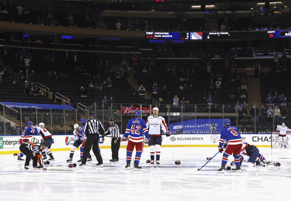 Washington Capitals and New York Rangers fight in the opening seconds of an NHL hockey game Wednesday, May 5, 2021, in New York. (Bruce Bennett/Pool Photo via AP)