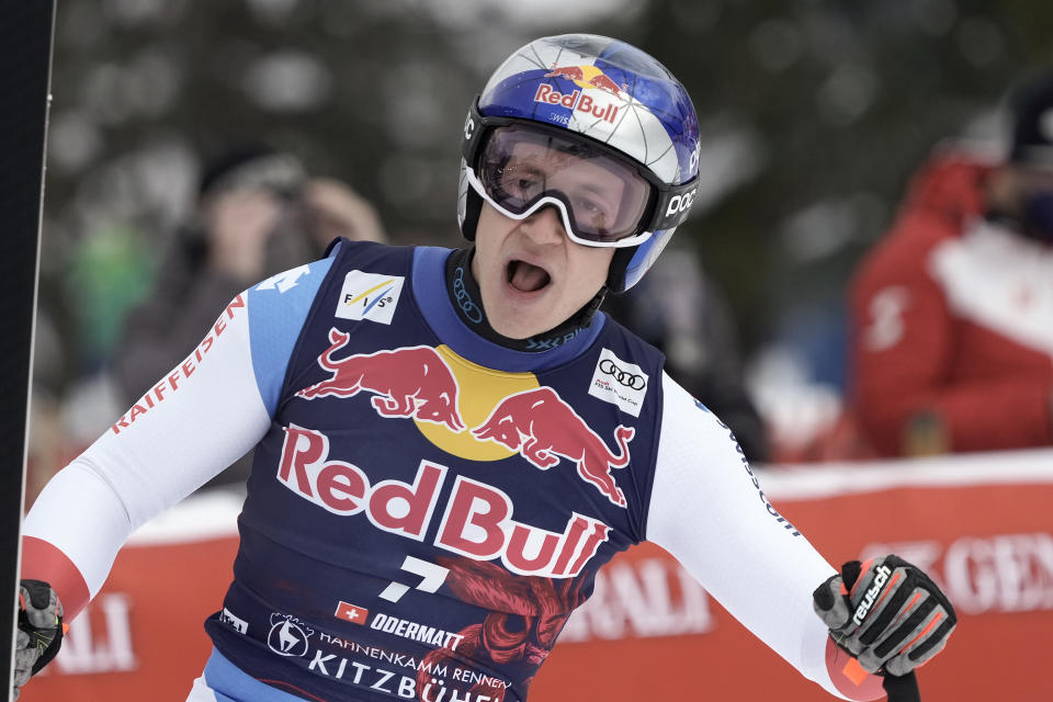 FILE - Switzerland's Marco Odermatt celebrates at the finish area of an alpine ski, men's World Cup downhill, in Kitzbuehel, Austria, on Jan. 23, 2022. ( Looking for the Next Big Thing in Alpine skiing? Look no further than Marco Odermatt. The 24-year-old from Switzerland is a potential superstar who won five gold medals at the junior world championships in 2018 and is currently leading the overall World Cup standings. He’s a legitimate medal threat in three events at the upcoming Beijing Olympics with strong results in giant slalom, super-G and downhill this season. (AP Photo/Giovanni Auletta, File)