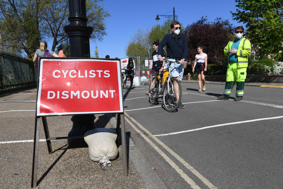 Signage advising cyclists dismount on Hammersmith Bridge, London, as the UK continues in lockdown to help curb the spread of the coronavirus.