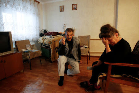 Local residents sit inside their house in the Oktyabrsky district of Donetsk, Ukraine, November 1, 2017. REUTERS/Alexander Ermochenko