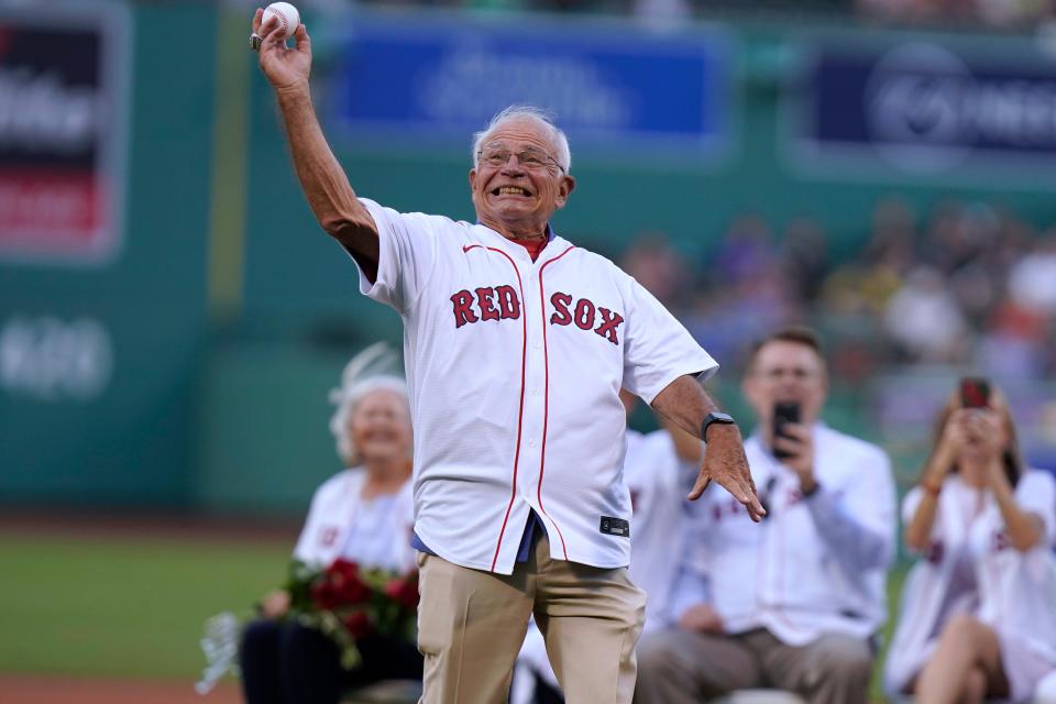 Boston Red Sox broadcaster Joe Castiglione throws a ceremonial first pitch before a baseball game in 2022 between the Cleveland Guardians and the Red Sox. The Red Sox honored Castiglione before the game for his 40 years on the air with the team.