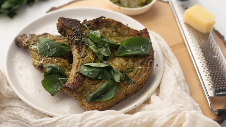 Pork chops with basil leaves