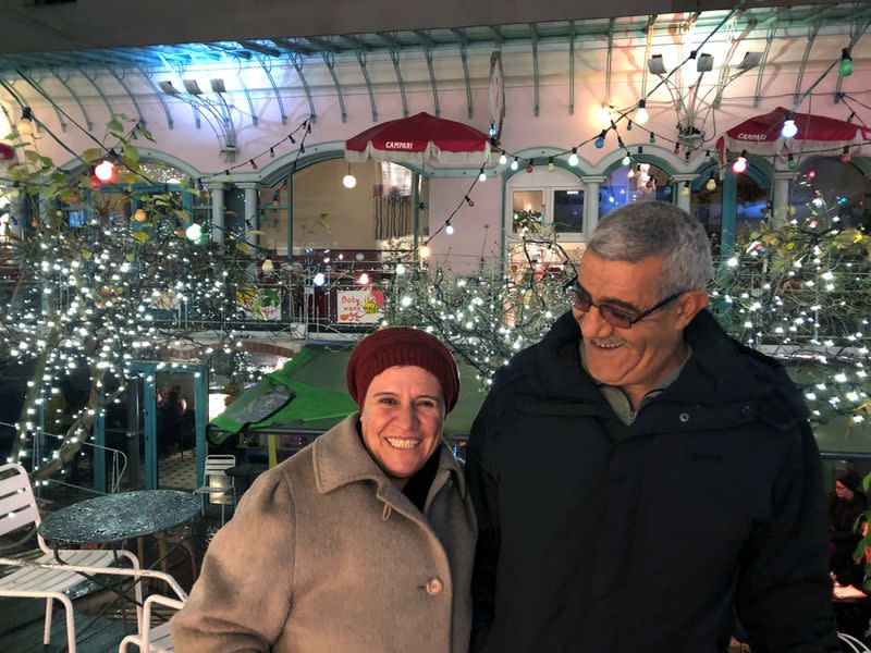 Ghada Zitouni, Isam Alkousaa pose for a picture near a cafe in Berlin