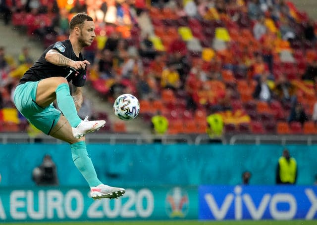 Austria’s Marko Arnautovic jumps to control the ball