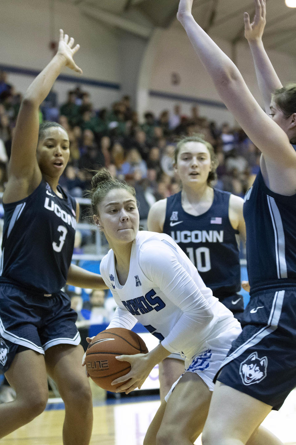 Memphis guard Aerial Wilson, center, looks to pass defended by Connecticut Megan Walker (3), guard Molly Bent (10) and forward Kayla Irwin, right, in the first half of an NCAA college basketball game Tuesday, Jan. 14, 2020, in Memphis, Tenn. (AP Photo/Nikki Boertman)