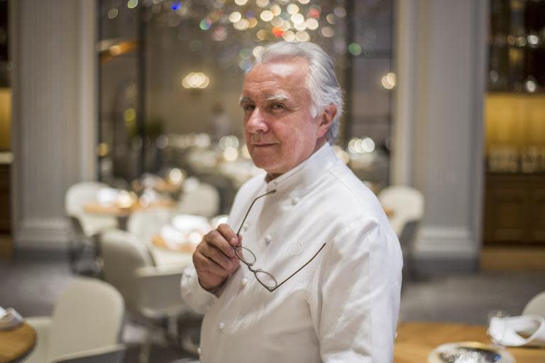 Alain Ducasse poses in his restaurant at the Plaza Athenee hotel in Paris on September 2, 2014