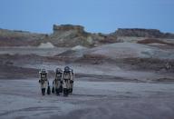 Members of Crew 125 EuroMoonMars B mission return after collecting geologic samples for study at the Mars Desert Research Station (MDRS) in the Utah desert March 2, 2013. The MDRS aims to investigate the feasibility of a human exploration of Mars and uses the Utah desert's Mars-like terrain to simulate working conditions on the red planet. Scientists, students and enthusiasts work together developing field tactics and studying the terrain. All outdoor exploration is done wearing simulated spacesuits and carrying air supply packs and crews live together in a small communication base with limited amounts of electricity, food, oxygen and water. Everything needed to survive must be produced, fixed and replaced on site. Picture taken March 2, 2013. REUTERS/Jim Urquhart (UNITED STATES - Tags: SCIENCE TECHNOLOGY SOCIETY ENVIRONMENT) ATTENTION EDITORS: PICTURE 27 OF 31 FOR PACKAGE 'MARS IN THE DESERT' SEARCH 'JIM MARS' FOR ALL IMAGES