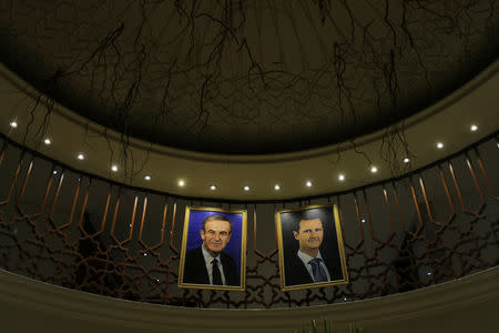 Pictures of Syrian president Bashar al-Assad and his father Hafez al-Assad are seen inside a hotel in Damascus, Syria, September 16, 2018. REUTERS/Marko Djurica