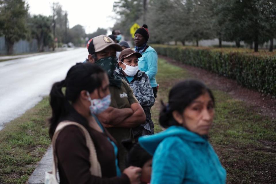 Food is distributed during a mobile food pantry in the agricultural community of Immokalee on February 16, 2021 in Immokalee, Florida. The Harry Chapin Food Bank has weekly distributions in the town which has a poverty rate of over 40% and has a population made up primarily of agricultural workers. The mobile food pantry gives out food packages for over 800 families after seeing a surge in need since the Covid-19 outbreak.