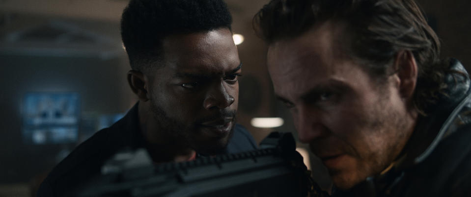This image released by STXfilms shows Stephan James, left, and Taylor Kitsch in a scene from "21 Bridges," in theaters on Nov. 22. (STXfilms via AP)
