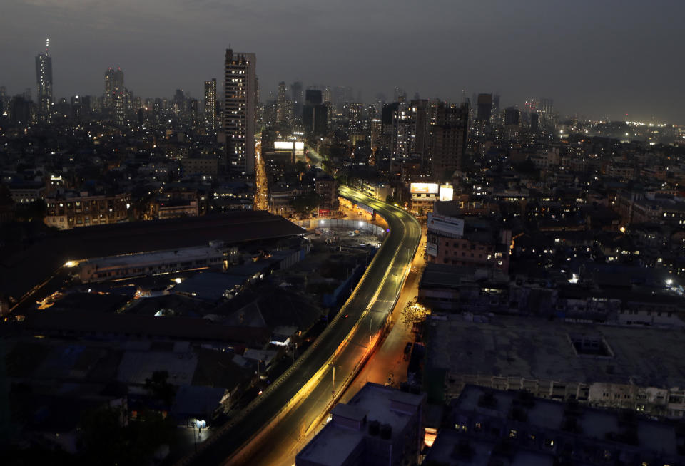 A road is seen deserted in Mumbai, India, Friday, March 27, 2020. An unprecedented order keeping India's 1.3 billion people at home for all but essential trips to places like markets or pharmacies is meant to keep the virus from surging and overwhelming an already strained health care system. India's finance ministry announced a 1.7 trillion ($22 billion) economic stimulus package that will include delivering grains and lentil rations for three months to 800 million people, some 60% of the world's second-most populous country. (AP Photo/Rajanish Kakade)