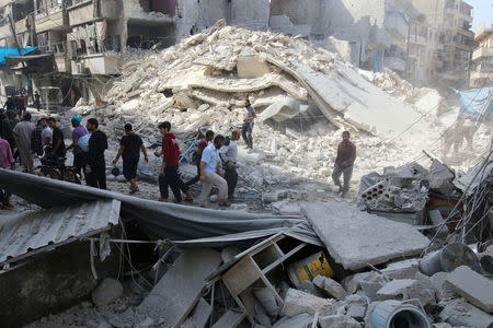 People inspect the damage at a market hit by airstrikes in Aleppo's rebel held al-Fardous district, Syria October 12, 2016. REUTERS/Abdalrhman Ismail