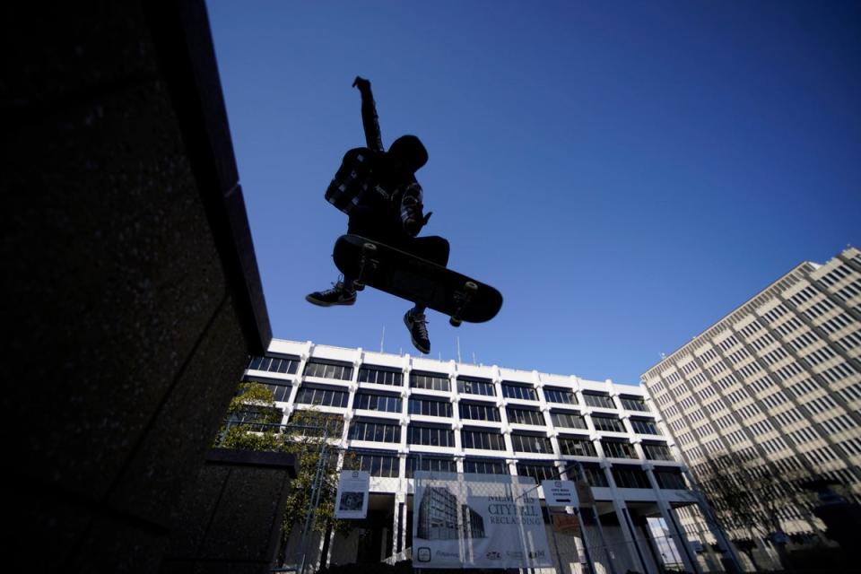 Skateboarder Kam Blakely skates in front of city hall in remembrance of Tyre Nichols (AP)