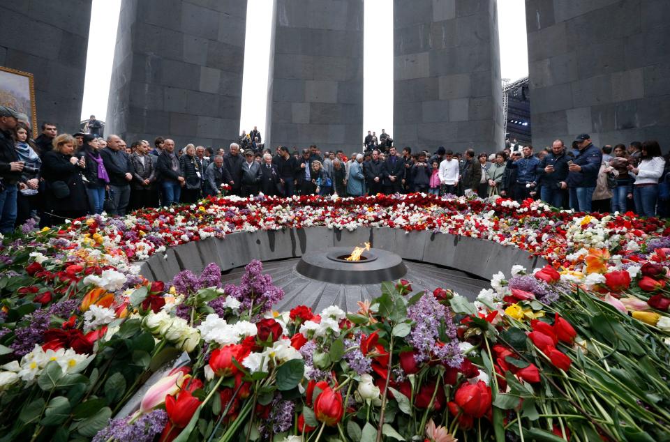 People lay flowers at a memorial to Armenians killed by the Ottoman Turks as they mark the centenary of the genocide in Yerevan, Armenia, on April 24, 2015.