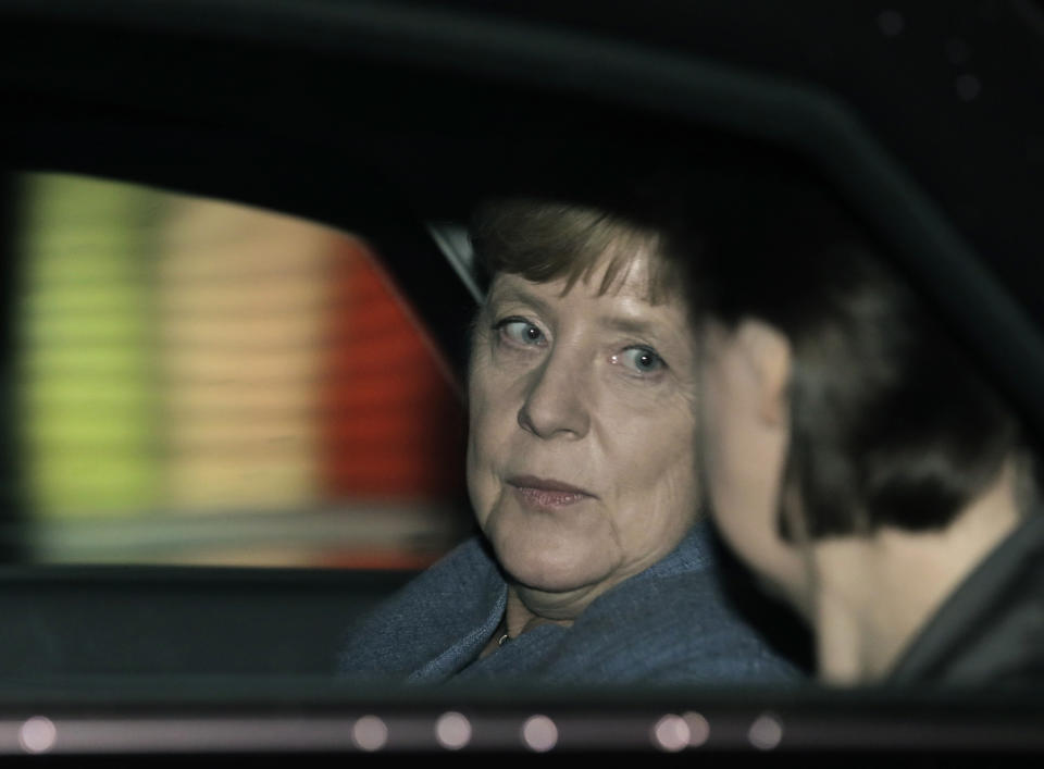 FILE - German Chancellor Angela Merkel talks to her head of office Beate Baumann, right, as she leaves after a TV talk of the party leaders in Berlin, Germany, Sunday, Sept. 24, 2017. Former German Chancellor Angela Merkel's memoirs will be released in late November. She co-wrote the book with her longtime assistant and adviser, Beate Baumann.(AP Photo/Gero Breloer, File)