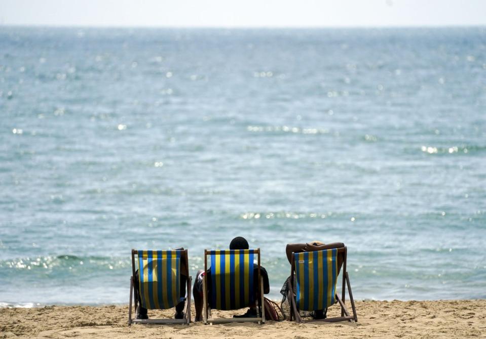 People enjoying the hot weather on Bournemouth beach after temperatures topped 40C in the UK for the first time (Steve Parsons/PA) (PA Wire)