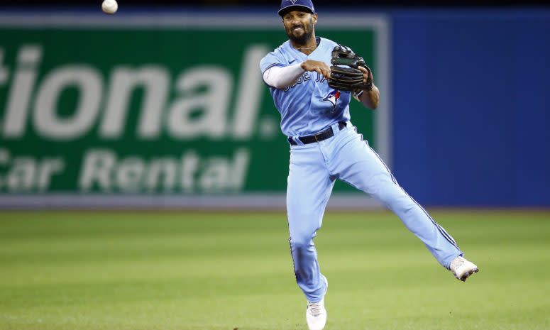 Blue Jays infielder Marcus Semien makes a jumping throw.