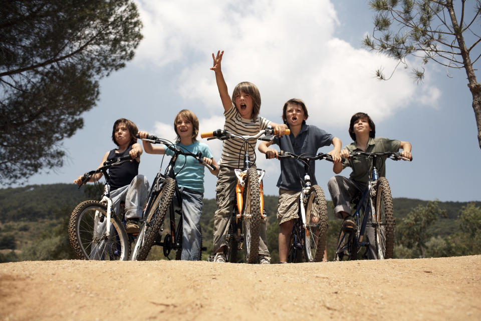 A group of children outside on their bikes