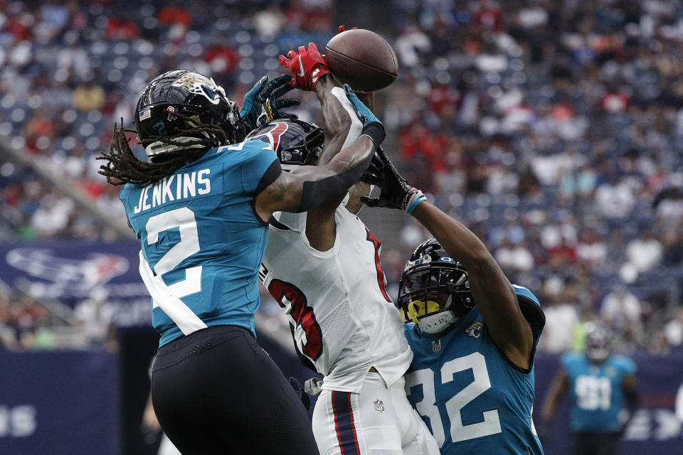 HOUSTON, TEXAS - SEPTEMBER 12: Brandin Cooks #13 of the Houston Texans attempts to make a catch against Rayshawn Jenkins #2 of the Jacksonville Jaguars during the first quarter at NRG Stadium on September 12, 2021 in Houston, Texas. (Photo by Bob Levey/Getty Images)