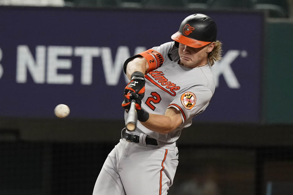 Baltimore Orioles' Gunnar Henderson (2) hits a single during the second inning of a baseball game against the Texas Rangers in Arlington, Texas, Monday, April 3, 2023. (AP Photo/LM Otero)