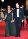 <p>The pregnant duchess housed her bump in a dark green Jenny Packham gown for the 2018 ceremony.</p>