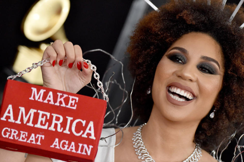At a different event, Joy holds up a bag that says "make America great again"