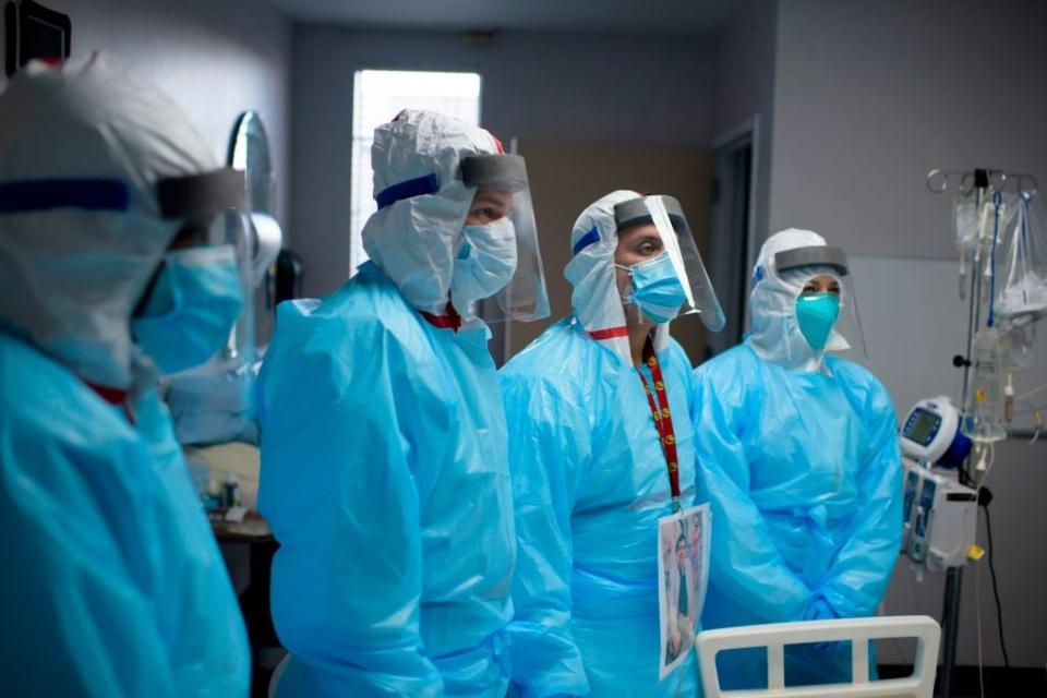 <p>Medical staff are pictured in a Houston, Texas, hospital on Friday as a new forecast put the estimated death toll at 500,000 by April</p> (AFP /AFP via Getty Images)