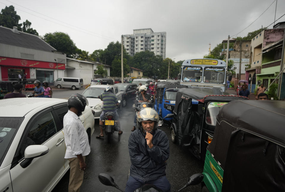 Scooterists and motorists wait in long queues at a fuel station in in Colombo, Sri Lanka, Saturday, June 11, 2022. Sri Lanka's economic crisis, the worst in its history, has completely recast the lives of the country's once galloping middle class. For many families that never had to think twice about fuel or food, the effects have been instant and painful, derailing years of progress toward lifestyles aspired to across South Asia. (AP Photo/Eranga Jayawardena)