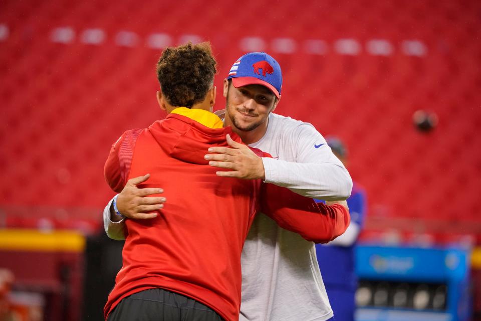 Kansas City Chiefs quarterback Patrick Mahomes, left, hugs with Buffalo Bills quarterback Josh Allen before the start of an NFL football game between the Kansas City Chiefs and the Buffalo Bills Sunday, Oct. 10, 2021, in Kansas City, Mo. (AP Photo/Ed Zurga)